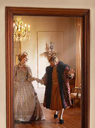 Renaissance, man and woman holding hands in royal castle together with vintage love, romance and...