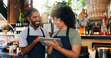 Tablet, restaurant bartender and happy people discussion on checklist for alcohol stock, store trade or inventory. Smile, small business team and entrepreneur collaboration on drinks supply chainの写真素材