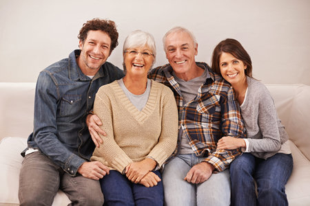 Couple, senior parents and portrait on sofa with smile, hug and care with bonding, relax and pride...