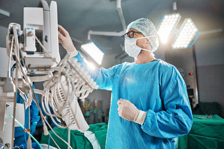 Healthcare, scrubs and doctor with machine in theatre for surgery, cardiovascular operation or...
