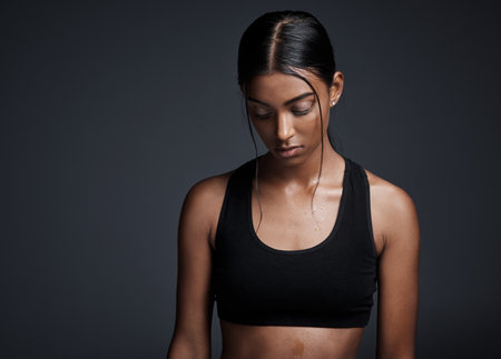 Indian woman, thinking and exercise workout in studio or thoughts of fitness, training or black background. Female person, mockup space and future goal with healthy weight loss, routine or challengeの写真素材