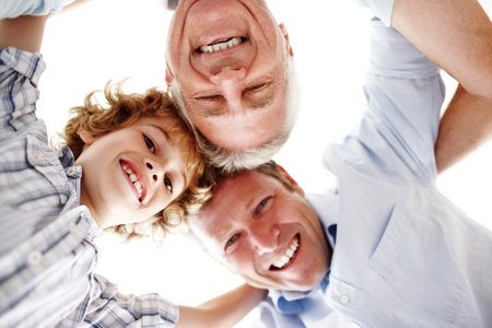 Portrait of grandpa, dad and child in circle for bonding, relationship and generations. Family home, happy and huddle of grandfather, father and young boy for love, relax and fun together on weekendの写真素材