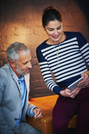 Tablet, collaboration or planning with mentor and employee at desk in office together for feedback....