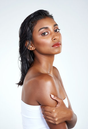 Portrait, skincare and beauty of Indian woman in studio for body wellness isolated on a white background in spa. Face, cosmetics and serious model in makeup for dermatology, shine or glow for healthの写真素材