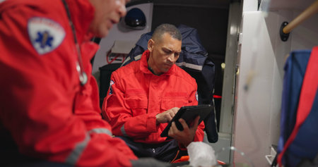 Ambulance, patient and paramedic with tablet for healthcare with technology, communication and doctor update. Ems, accident and victim with oxygen mask, digital medical service and transportationの写真素材