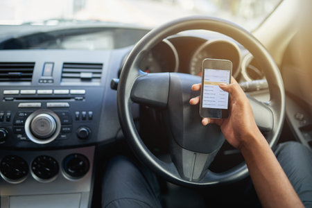 Phone, texting and driving with hands of person on steering wheel with scroll, danger and risk. Road...