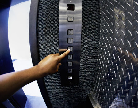 Person, elevator and button with hand to floor going up in hotel building, architecture or...