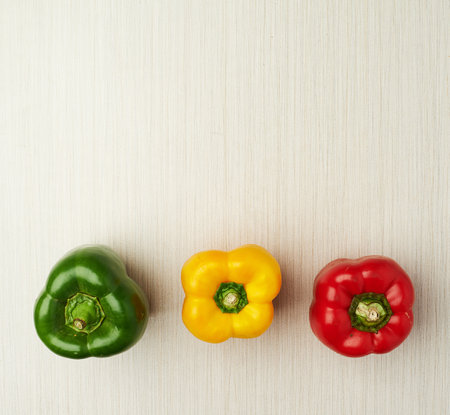 Vegetables, nutrition and bell pepper on table top for wellness, health and diet in studio. Ingredients, green and red isolated for eating, food and weight loss in house for prepare and cook.の写真素材