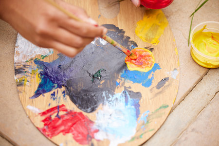 Person, hand and paint palette as creative for art therapy or watercolor hobby, talent or expression. Fingers, tools and top view of acrylic in studio workshop for handmade craft, learning or classの写真素材