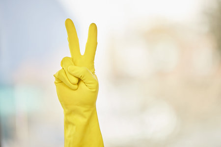 Person, hands or peace sign in gloves for cleaning or good job with mockup space on blurred...