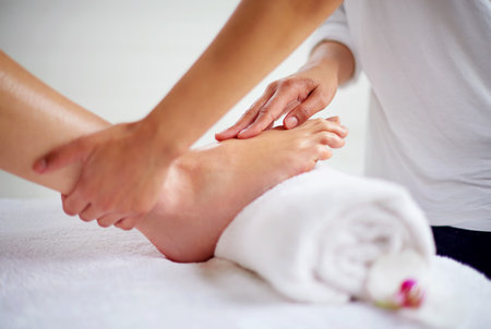 Foot, hands and pressure massage with spa for treatment, beauty and skincare at luxury resort with wellness. Pedicure, cosmetics and people for physical therapy with healing for self care and reliefの写真素材