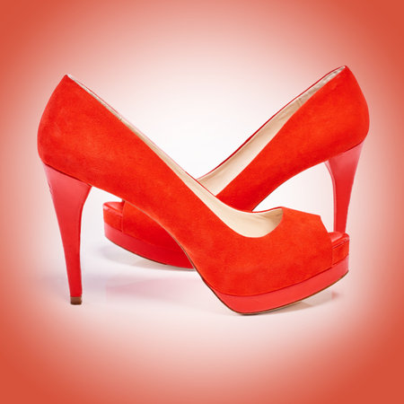 High heels, fashion and women shoes in studio for luxury, designer and retail sale or discount. Elegance, stylish and female footwear with fancy or formal accessory isolated by red background.の写真素材