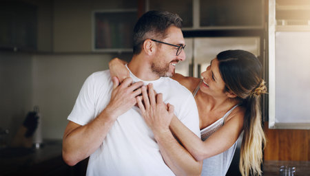 Love, hug and happy couple in home together with care, kindness and support in morning. Marriage,...