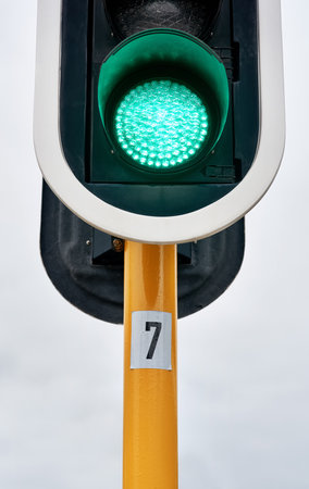 Green traffic light, city or outdoor sign for control, movement or rules for safety on urban street. Go symbol, background or icon for road, sidewalk or signal for public or transportation in townの写真素材