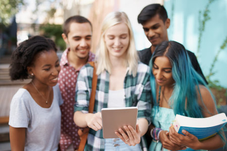 Students, university and tablet on campus for website, internet and connectivity outdoor. People, study and college youth with technology for education, tuition and email for schedule with diversityの写真素材
