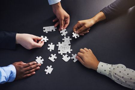Hands, puzzle and business people with teamwork, planning and brainstorming for project or cooperation. Closeup, staff or group with mission or problem solving with solution, collaboration or synergyの写真素材