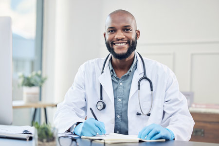Doctor, portrait and clinic with smile, writing and record for prescription in healthcare as professional. African male physician and hospital for consultation, medical and wellness with stethoscopeの写真素材