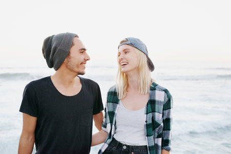 Happy, couple and walk on beach for date on holiday or adventure on vacation in summer with love....