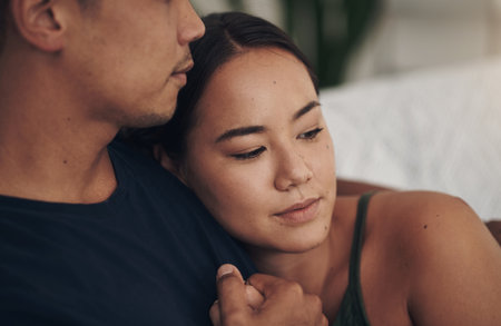 Couple, hug and relax on couch for love, security and romance on home date and weekend. People, peace and bonding in embrace for marriage, support and trust in connection or comfort in closeupの写真素材