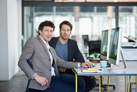 Business men, computer monitor and portrait in office for company career and online planning in project management on web. Professional male analyst, smile and tech for email, internet and researchの写真素材