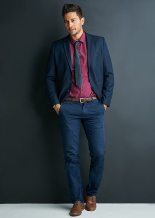 Portrait, businessman and grey background or professional, studio and formal. Confidence, corporate and man or male employee, mockup space and career or consultant, suit and isolated in fashionの写真素材