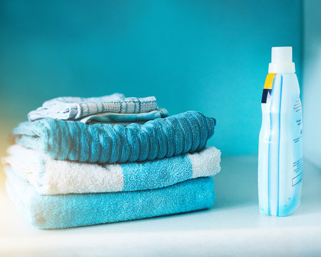 Washing machine, towel and clean laundry in blue background with stack, product and mockup. Lens flare, fabric and electrical for energy, efficiency and furniture with stain removal for clothesの写真素材