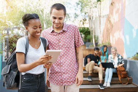 University, students and tablet on campus for education, learning and tuition outdoor. People, study...