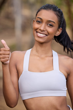 Woman, thumbs up and portrait for fitness, exercise or cardio training in outdoor activity. Active...