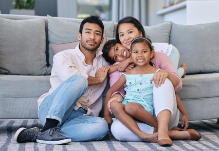 Family, kids and smile in living room for bonding, love and growth for child development. Parent, girl and satisfied at home with care, childhood memories and together for trust, support and portraitの写真素材