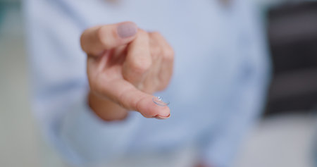 Optical, vision and contact lenses on finger for prescription eye correction lens or sight. Healthcare, hand and transparent eyewear for medical help with eyesight for option, choice or decisionの写真素材