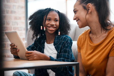 Girl, smile and mother with tablet at house for acceptance at private school, scholarship and education. Happy, woman and child on sofa with positive news, email and online learning for knowledgeの写真素材