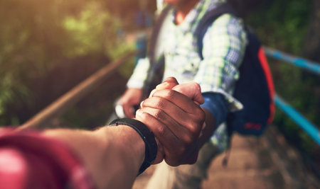 People, pov and holding hands for mountain hike or friends support for exercise challenge, trekking...