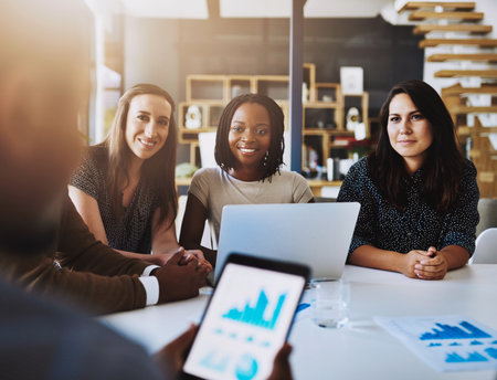 Tablet, screen and business people in meeting with statistics, charts and graphs for productivity growth. Data analysis, men and women with digital app for performance review, development or planningの写真素材