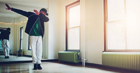 Dance, music and man in studio with practice for concert, recital or performance at creative school. Art, hip hop and dancer moving to song, playlist or radio for rehearsal with energy and rhythm.の写真素材