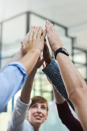 Office, business and hands high five in air for success or solidarity with strength, bonding and together for project. People, diversity and encouragement for support or synergy and community trust.の写真素材