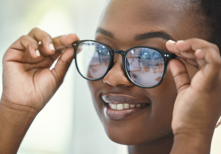Eye care, exam and black woman with glasses at store for vision, optometry or prescription lens. Retail, wellness and customer with spectacles frame for optics, eyesight or ophthalmology testingの写真素材