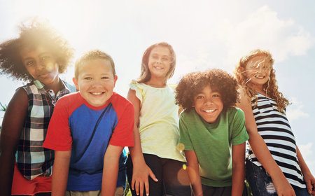Children, friends and portrait or outdoor group in sunshine for school trip or bonding, diversity or...