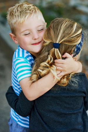 Happy, siblings and embrace with love in outdoor for bonding, family and holiday at house in summer for memory. Smile, girl and child on adventure, together and relationship with care in Greeceの写真素材