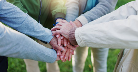 Elderly people, hands together and teamwork for community, trust or support together in nature....