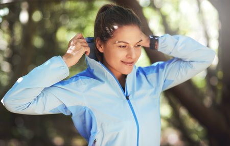 Happy, woman and fitness with hike or exercise on trail run for workout goals or running challenge. Smile, female person and health with stretch for sport adventure or training outdoor in natureの写真素材