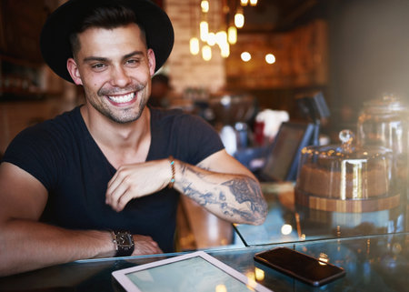Portrait, coffee shop and man in cafe with tablet for small business, stock inventory and store website. Restaurant, hospitality and owner by counter on digital tech for orders, online and internetの写真素材