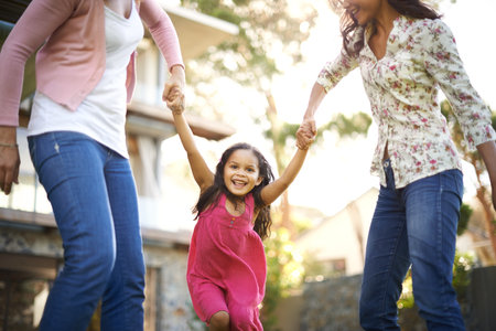 grandmother, mom or girl in garden to play with love, care or wellness outdoors for bonding in home. Holding hands, family and happy child in nature to swing with grandma, kid and smile with parentの写真素材