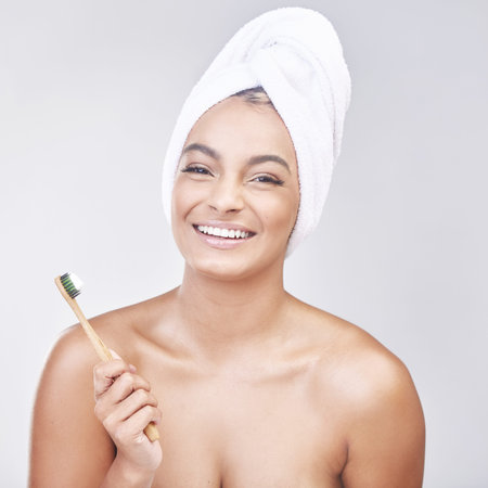 Woman, toothbrush and portrait for brushing teeth in studio with oral hygiene, dental care or...