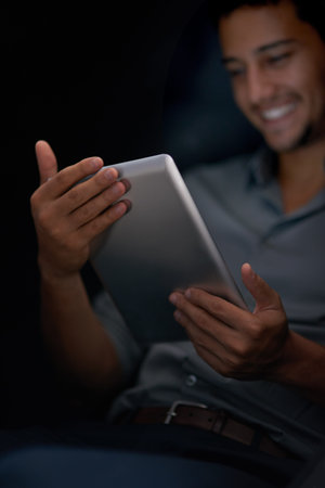 Happy man, tablet and night with smile for meme, social media app or comic video on web, internet or...