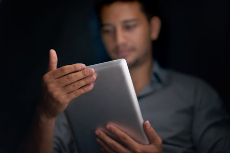 Man, dark background and tablet for cybersecurity with software update for scammer protection....