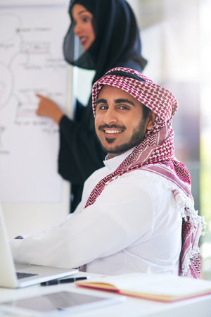 Arab, businessman and portrait for presentation in office, muslim employee and strategy planning for company. Confident, coworker and happy for our vision, boardroom and collaboration in Dubaiの写真素材