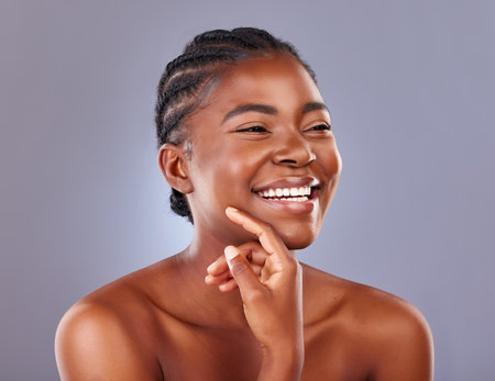 Black woman, cosmetics and beauty with thinking, studio and happy for results with healthy skin in gray background. African, female person and smile for skincare, pride and glow for dermatologyの写真素材