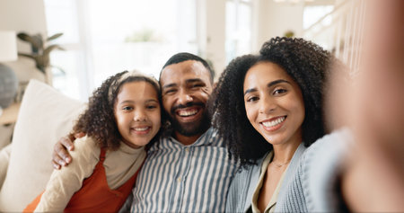 Parents, girl and selfie on couch for portrait with love or care, relax and family bonding for memory or connection. Mom, dad and together in home for comfort or safety on weekend, hug and happiness.の写真素材