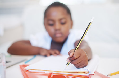 Homework, education and black girl writing, book and knowledge with thinking, activity and artistic. Closeup, student and kid with ideas, childhood development and school with creativity and pencilの写真素材