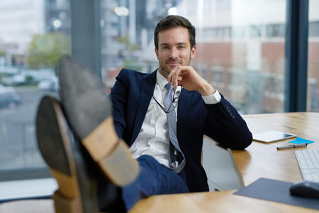 Businessman, feet up and portrait on break in office, workplace or company as advertising executive....